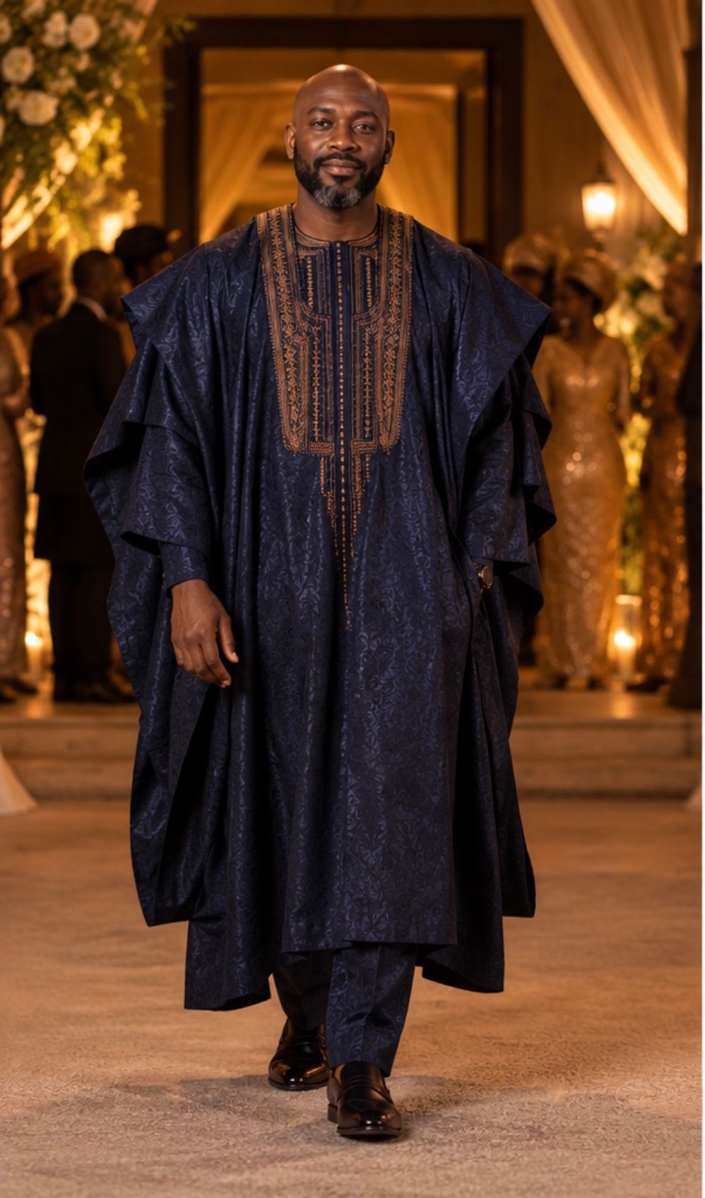 Midnight-blue agbada with layered bronze embroidery around the neckline, front view.
